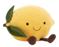 a transparent render of a yellow lemon plushie with two leaves, a cartoon smile, and two brown feet sitting down.
